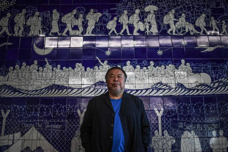 O artietsa chinês Ai Weiwei posa em frente à obra "Odissey", feita em azulejos da Viúva Lamego,  na inauguração da exposição "Rapture", a maior de sua carreira, que ficou em cartaz na Cordoaria Nacional, em Lisboa, em 2021 