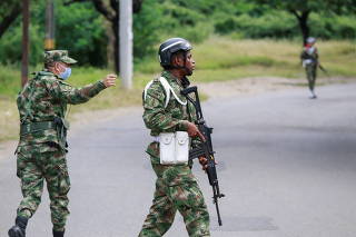 Soldiers patrol around a military battalion where a car bomb exploded, according to authorities, in Cucuta