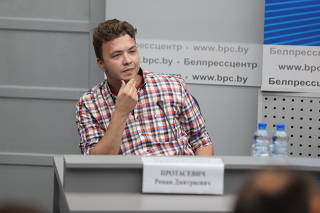 Jailed Belarus journalist Roman Protasevich takes part in a press conference in Minsk