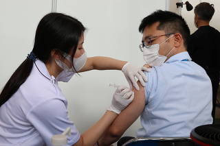 A man gets an injection of COVID-19 vaccination at the Tokyo Metropolitan Government office in Tokyo