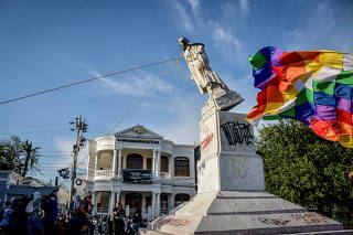 Demonstrators tear down a statue of Cristobal Colon, also known as Christopher Columbus, during protests, in Barranquilla