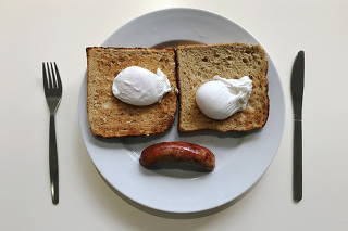 FILE PHOTO: A breakfast of sausage, eggs and toast is pictured in an office canteen in London