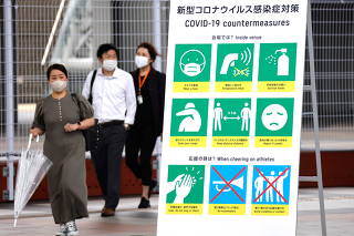 A sign for coronavirus disease (COVID-19) countermeasures is pictured during the opening of the IBC/MPC media center in Tokyo