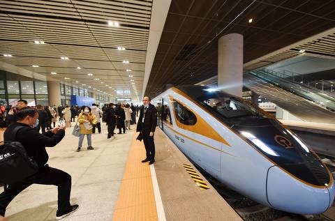 (201226) -- XI'AN, Dec. 26, 2020 (Xinhua) -- Passengers pose for photos in front of a Fuxing bullet train expected to operate on the high-speed railway linking Yinchuan with Xi'an in Xi'an, northwest China's Shaanxi Province, on Dec. 26, 2020. A new high-speed railway linking Yinchuan, capital of Ningxia Hui Autonomous Region, with Xi'an, capital of Shaanxi Province, both in western China, began operation from Saturday. 
 The 610-km railway was built with an investment of 80.5 billion yuan (about 12.33 billion U.S. dollars),and the speed of the train has been set to 250 km per hour. (Xinhua/Zhang Bowen)