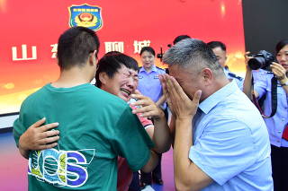 Guo Gangtang and his wife reunite with their son Guo Xinzhen, who was abducted 24 years ago, in Liaocheng