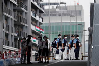 Police officers are seen at a security checkpoint at the entrance to the Athletes Village ahead of the Tokyo 2020 Olympic Games in Tokyo