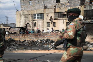 Members of the military patrol through the streets of Alexandra township as the country deploys the army to quell unrest linked to the jailing of former President Jacob Zuma, in Johannesburg