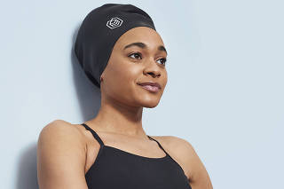 Alice Dearing, the first Black female swimmer to represent Britain at the Olympics, models the ÔSoul Cap.Õ (Luke Hutson Flynn via The New York Times)