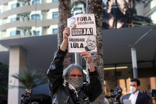 A man protests in front of Vila Nova Star Hospital, in Sao Paulo