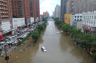 FILE PHOTO: Aerial view shows a flooded road section following heavy rainfall in Zhengzhou