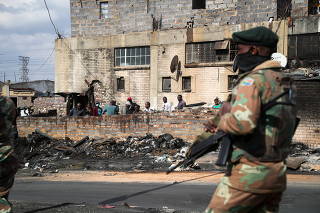 FILE PHOTO: Members of the military patrol through the streets of Alexandra township as the country deploys the army to quell unrest linked to the jailing of former President Jacob Zuma, in Johannesburg