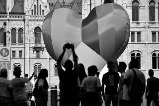 FILE PHOTO: NGOs put up a huge rainbow balloon at Hungary's parliament protesting against anti-LGBT law in Budapest