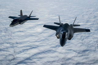 FILE PHOTO: A pair of RAF F-35B Lightning fighter jets flies over The English Channel