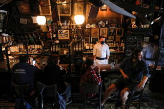 Restrictions ease for bars, allowing seating at the bar, during the coronavirus disease (COVID-19) in Manhattan, New York City