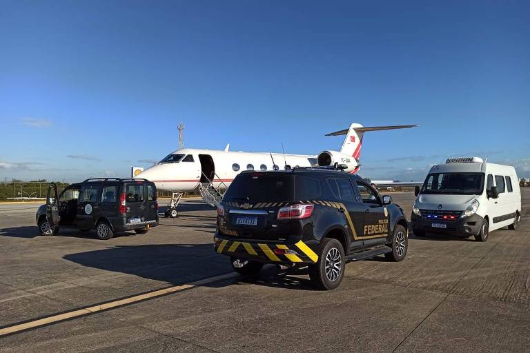 Imagem mostra veículos estacionados em pista de aeroporto ao lado de avião 