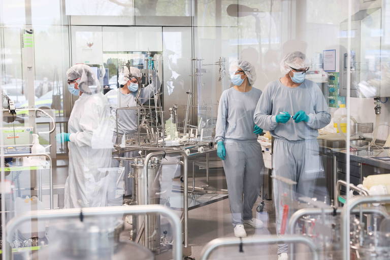 Funcionários em fábrica que produz a vacina Pfizer/BioNTech perto de Hamburgo, na Alemanha