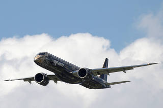 FILE PHOTO: An Embraer E195-2 performs during the 53rd International Paris Air Show at Le Bourget Airport near Paris