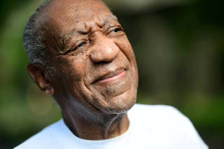 Bill Cosby looks on outside his house after Pennsylvania's highest court overturned his sexual assault conviction and ordered him released from prison immediately, in Elkins Park