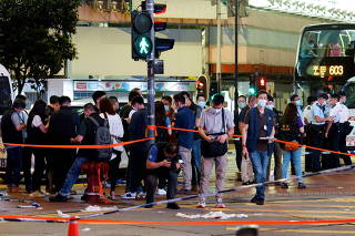 FILE PHOTO: Police take pictures at the site where a man allegedly stabbed a police officer, in Hong Kong