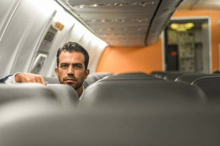 homem branco dentro de um avião vazio