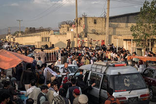 Hoping to flee the country, people gather near the airport in Kabul, Afghanistan on Saturday, Aug. 21, 2021. (Jim Huylebroek/The New York Times)