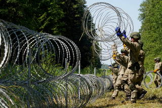 FILE PHOTO: Lithuania toughens Belarus border with razor wire to bar migrants