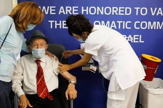 FILE PHOTO: Holocaust survivor Yehuda Widawski, 102, receives his third dose of a coronavirus disease (COVID-19) vaccine at Sourasky Medical Center (Ichilov Hospital) in Tel Aviv