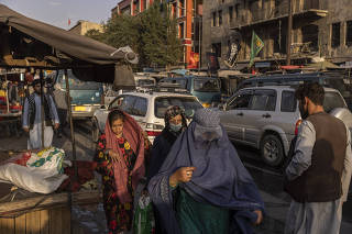 Shoppers visit a market in Kabul, Afghanistan, where groceries were available but at rising prices, Saturday, August 21, 2021. (Victor J. Blue/The New York Times)