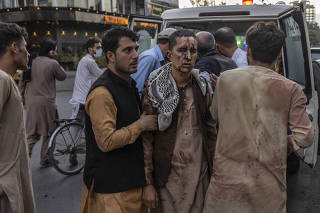 A person wounded in a bomb blast outside the international airport in Kabul, Afghanistan on Thursday, Aug. 26, 2021, arrives at a hospital in Kabul. (Victor J. Blue/The New York Times)