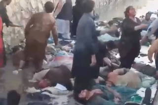 A view of injured people and dead bodies after an explosion near the Hamid Karzai International Airport, in Kabul