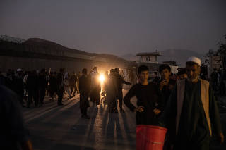 People are sent away from the scene of a bomb blast outside the Hamid Karzai International Airport in Kabul, Afghanistan on Thursday, Aug. 26, 2021. (Jim Huylebroek/The New York Times)