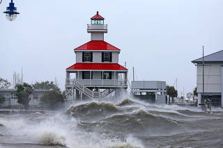 Waves crash against the New Canal Lighthouse on Lake Pontchartrain