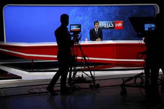 FILE PHOTO: Cameraman films a news anchor at Tolo News studio, in Kabul, Afghanistan