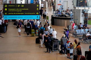 People wait in queues at Faro airport amid the coronavirus disease (COVID-19) pandemic, in Faro