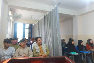 Students attend class under new classroom conditions at Avicenna University in Kabul