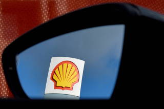 FILE PHOTO: A Shell logo is seen reflected in a car's side mirror at a petrol station in west London
