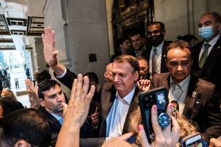 Brazil's President Jair Bolsonaro greets supporters outside his hotel during the 76th Session of the U.N. General Assembly in New York