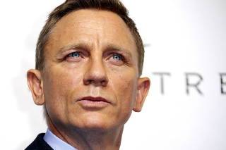 FILE PHOTO: Actor Daniel Craig poses for photographers on the red carpet at the French premiere of the new James Bond 007 film 