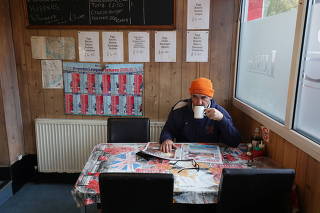 Scaffolder Frank Greene drinks tea at the Peterborough Cafe in Fulham