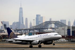 FILE PHOTO: FILE PHOTO: A United Airlines passenger jet takes off with New York City as a backdrop