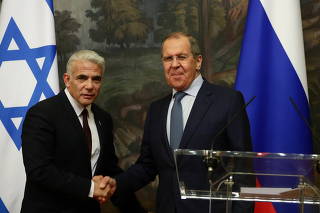 Russian Foreign Minister Sergei Lavrov and his Israeli counterpart Yair Lapid attend a news conference in Moscow