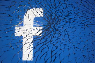 Facebook logo is displayed through broken glass in this illustration