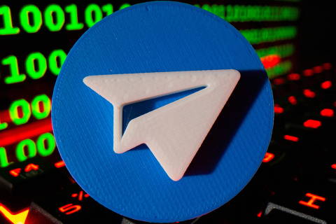 A 3D printed Telegram logo is pictured on a keyboard in front of binary code in this illustration taken September 24, 2021. REUTERS/Dado Ruvic/Illustration ORG XMIT: PPP-DAD0022