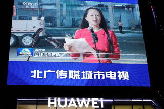 FILE PHOTO: A giant screen on top of a Huawei store shows images of Huawei Technologies Chief Financial Officer Meng Wanzhou, while broadcasting a CCTV state media news bulletin, outside a shopping mall in Beijing