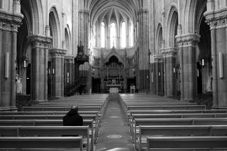 A man prays inside the Saint-Martin church in Vertou
