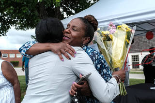 Andrea Kane gets a hug on her last day as superintendent of schools in Queen AnneÕs County, in Centreville, Md., June 3, 2021. (Michael A. McCoy/The New York Times)