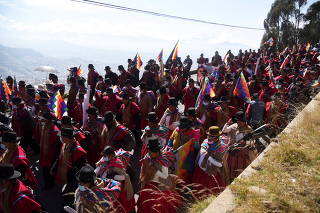 People march in support of Bolivian President Luis Arce and the indigenous Wiphala flag, in La Paz