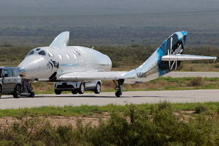 FILE PHOTO: Virgin Galactic's passenger rocket plane VSS Unity is towed after reaching the edge of space above Spaceport America