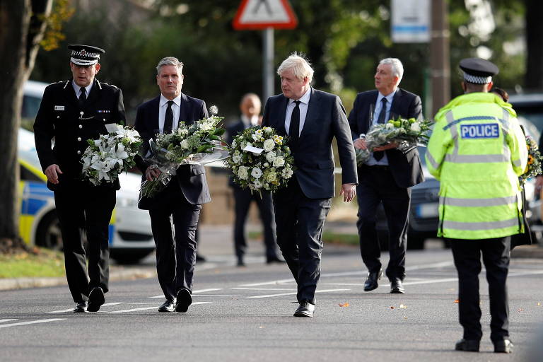 O líder do Partido Trabalhista, Keir Starmer, de terno, à esquerda, e o premiê Boris Johnson, carregam flores em homenagem a Amess 