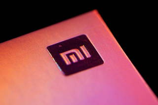 Xiaomi logo is seen on a smartphone box in this illustration